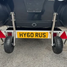 Single Transom Wheels in the down position ready for launching an inflatable boat onbard a Trailer with the HY60 RUS number plate