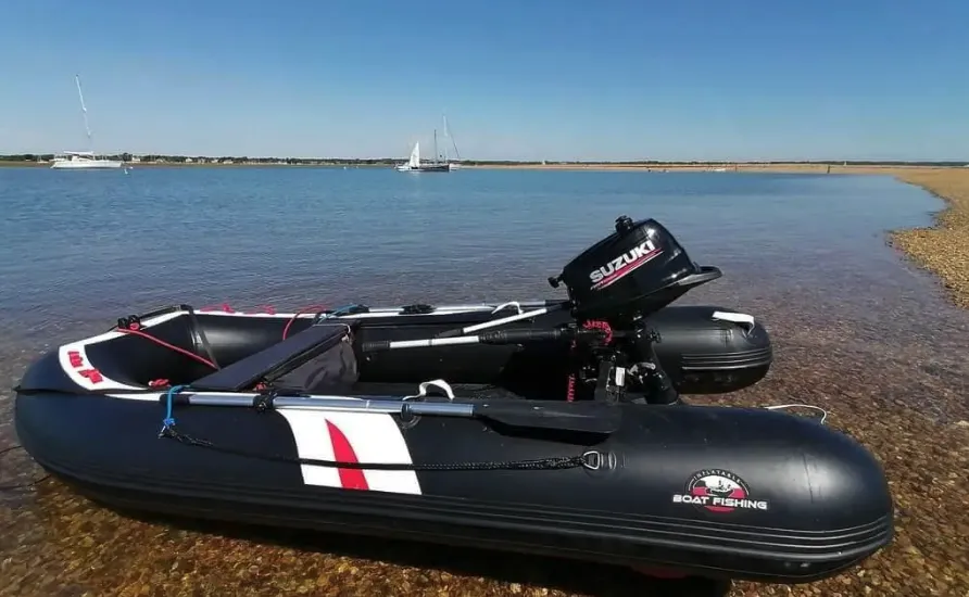 inflatable boat fishing hydrus next to the water