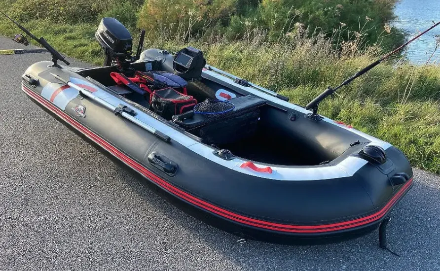 inflatable boat fishing hydrus next to the water