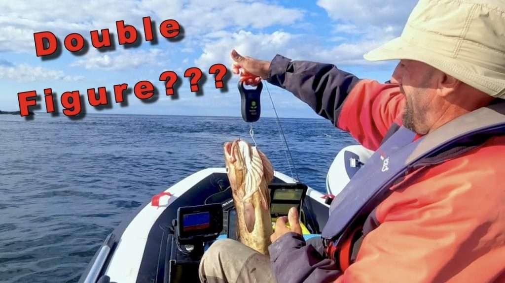 Man on a SIB weighing the fish he just caught